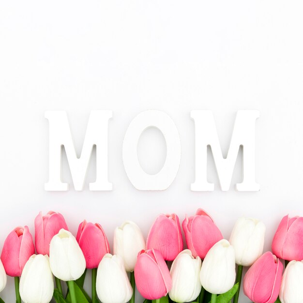 Flat lay of tulips and mom word