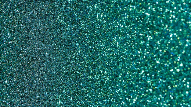 Free photo flat lay turquoise glitter background