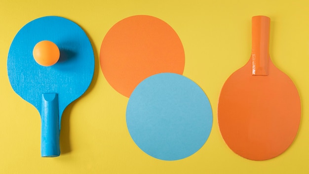 Flat lay of two ping pong paddles with ball