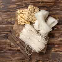 Free photo flat lay uncooked assortment of noodles on wooden background