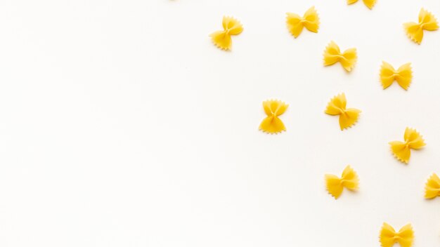 Flat lay uncooked farfalle arrangement with copy space