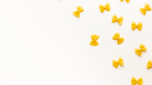 Flat lay uncooked farfalle arrangement with copy space