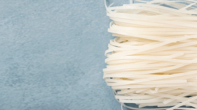 Flat lay uncooked white noodles with copy space
