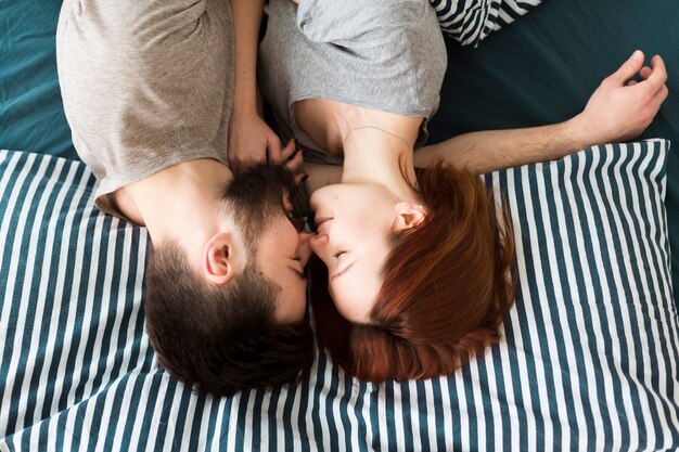 Flat lay upside down couple sitting in bed