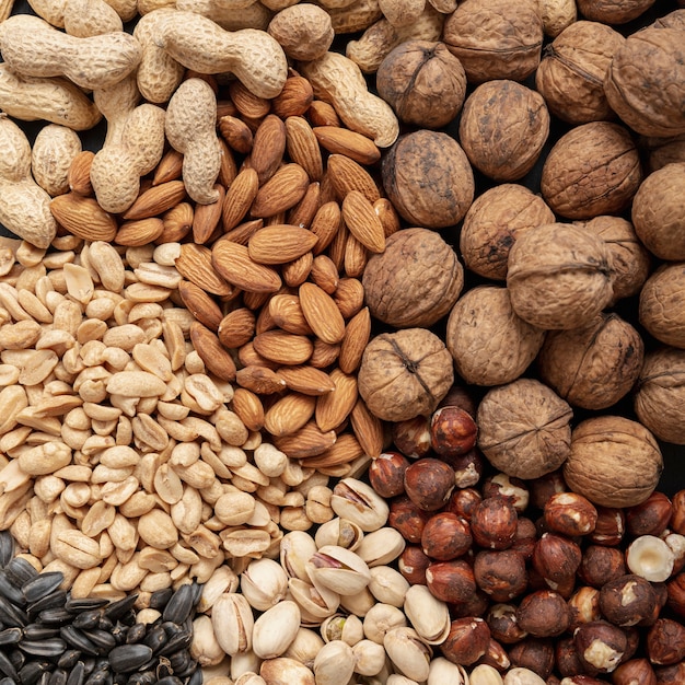 Flat lay of variety of nuts including almonds