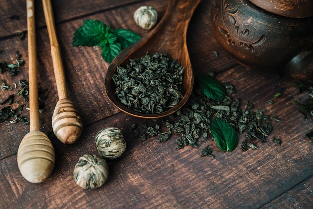 Flat lay variety of tea herbs and honey sticks