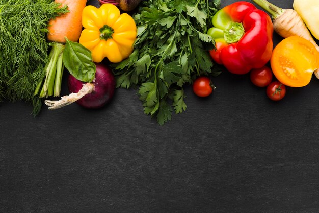 Flat lay vegetables arrangement on dark background with copy space