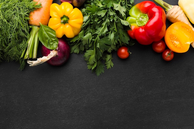 Flat lay vegetables arrangement on dark background with copy space