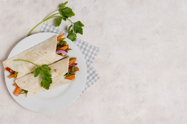 Flat lay of vegetables wraps with copy space