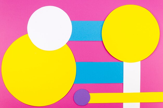 Free photo flat lay of vibrant paper circles and shapes