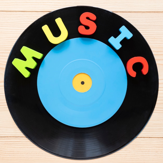 Flat lay vinyl disc with wooden background