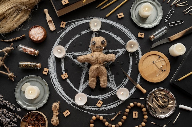 Flat lay voodoo doll and candles