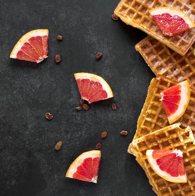 Flat lay of waffles with citrus