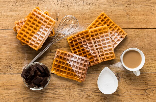 Flat lay of waffles with coffee and chocolate