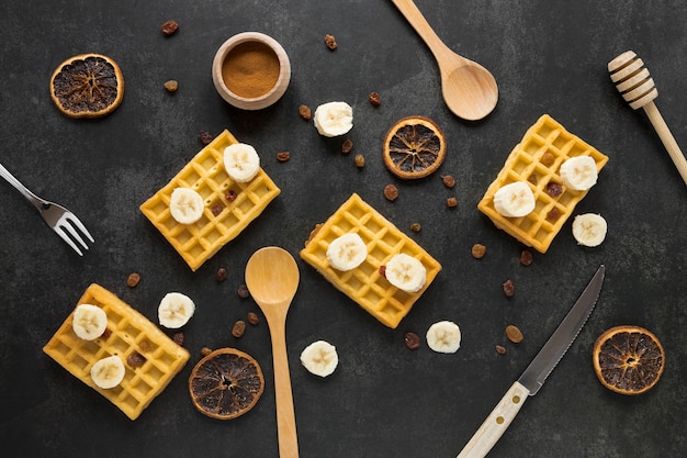 Flat lay of waffles with dried citrus and banana