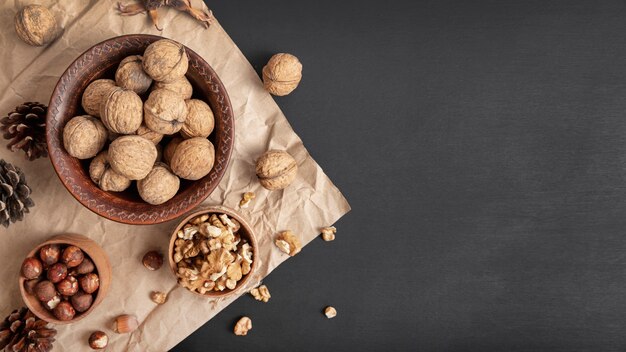 Flat lay of walnuts in bowl with hazelnuts