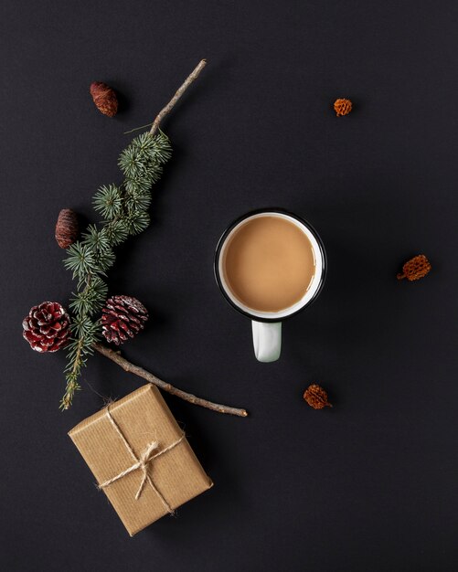 Flat lay warm beverage next to christmas decorations