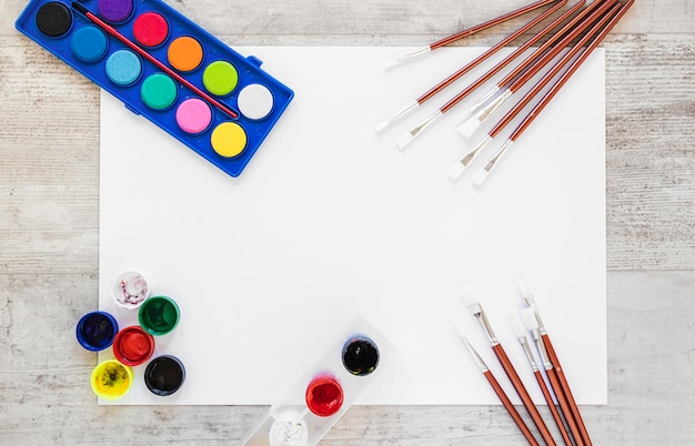 Flat lay watercolor paint and paint brushes