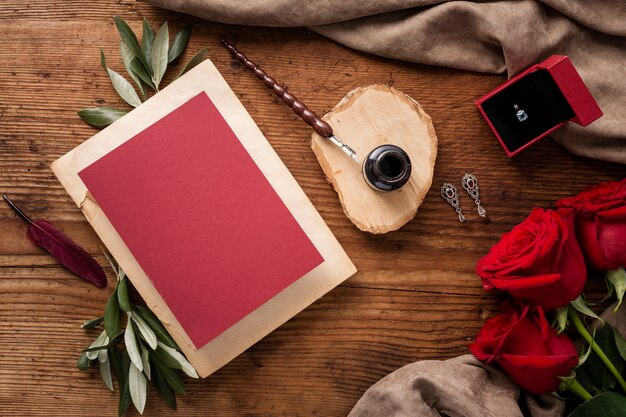 Flat lay wedding card and roses on table