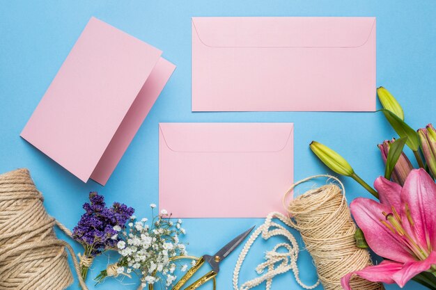 Flat lay wedding invitations on blue background