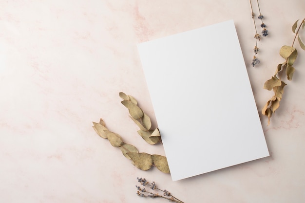 Free photo flat lay of wedding paper and dried plants