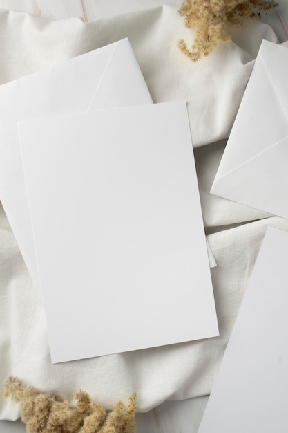 Flat lay of wedding paper and envelope with dried plants