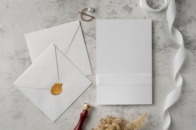 Flat lay of wedding paper and envelope with ribbon