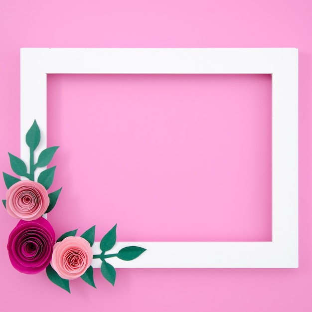 Free photo flat lay white floral frame on pink background