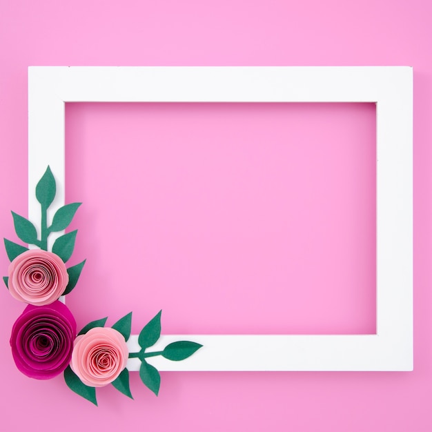 Flat lay white floral frame on pink background