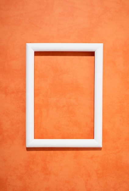 Flat lay white frame on orange background