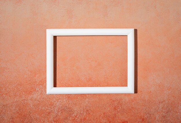 Flat lay white frame on orange background