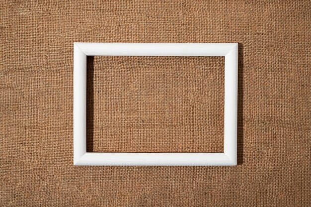 Flat lay white frame on textured material