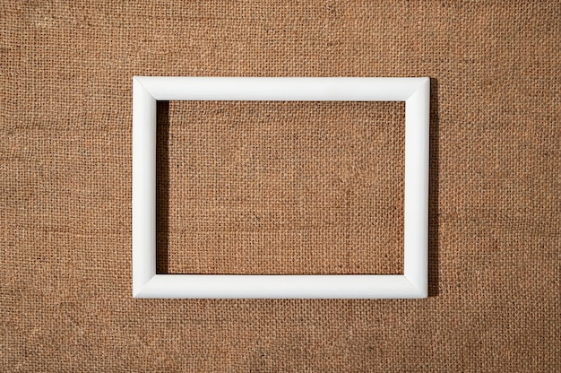 Flat lay white frame on textured material