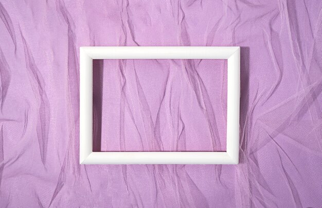Flat lay white frame on wrinkled material