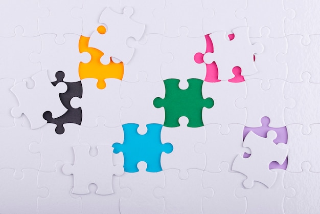 Flat lay white puzzle pieces and colorful background