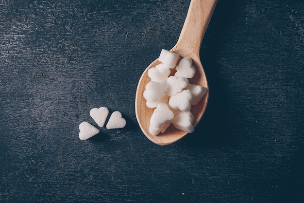 Flat lay white sugar in spoon