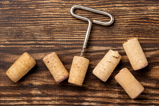 Free photo flat lay wine stopper collection beside corkscrew