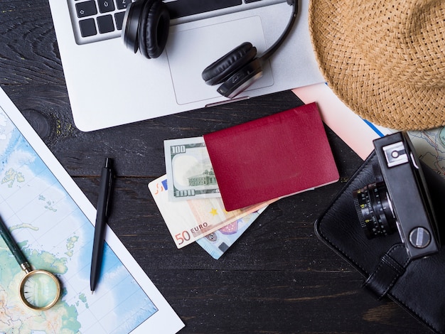 Flat lay with travelling accessories on wooden surface