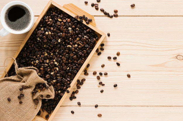 Flat lay of wood tray with coffee beans