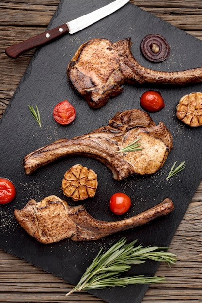 Flat lay wooden board with cooked meat