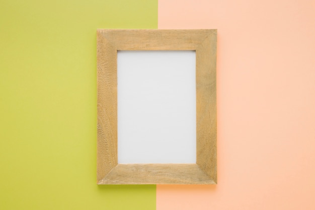 Flat lay wooden frame with bicolor background