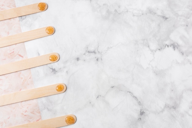 Flat lay wooden sticks on marble background