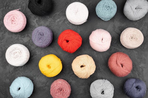 Flat lay of wool balls on slate background