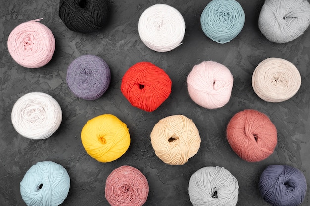 Flat lay of wool balls on slate background