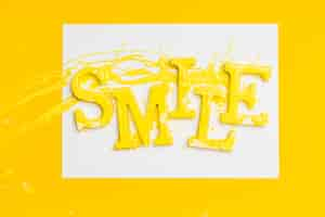 Free photo flat lay of word smile with paint