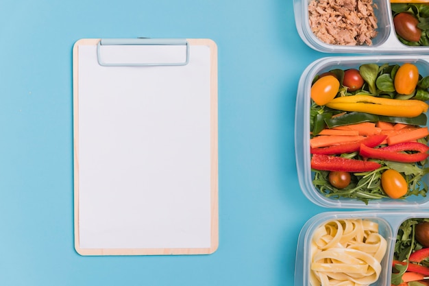 Flat lay work lunchboxes with blank notebook