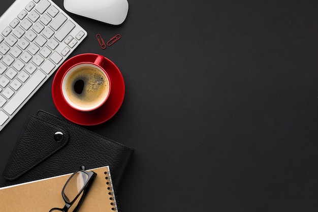 Flat lay of work space with coffee cup and keyboard