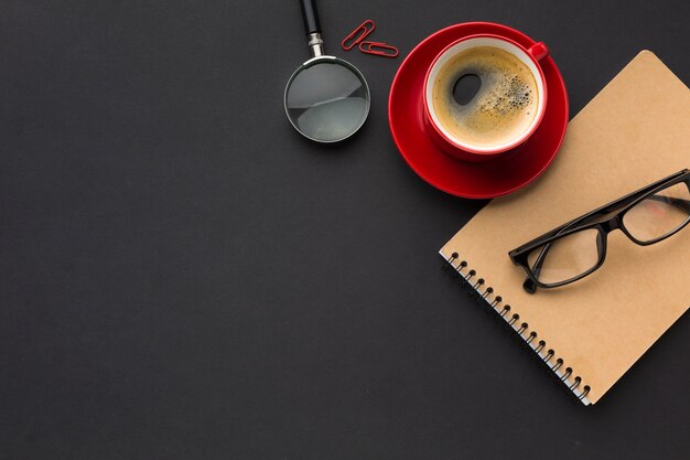 Flat lay of work space with coffee cup and notebook