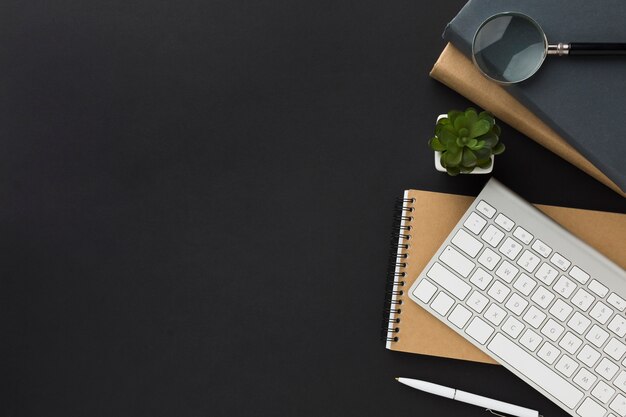 Flat lay of work space with notebook and keyboard