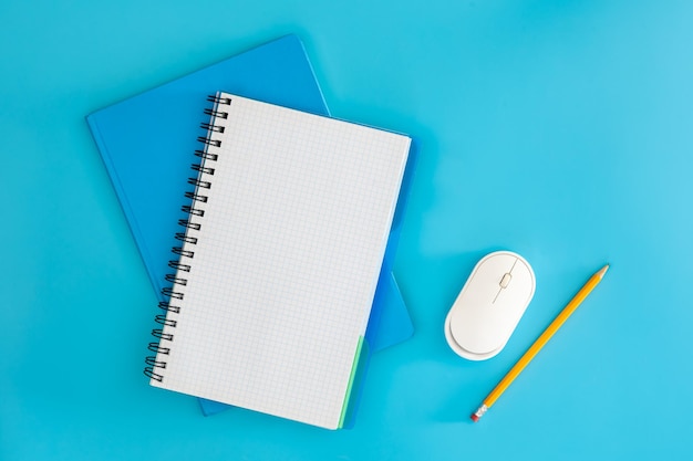 Free photo flat lay of working space with blank notebook computer mouse and pencil